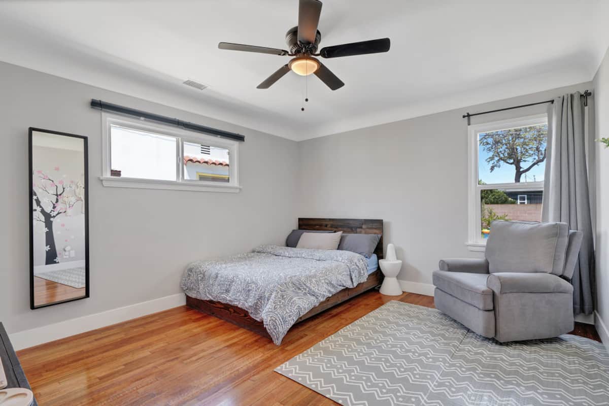 The second bedroom with a Queen bed, cosy armchair and soft rug